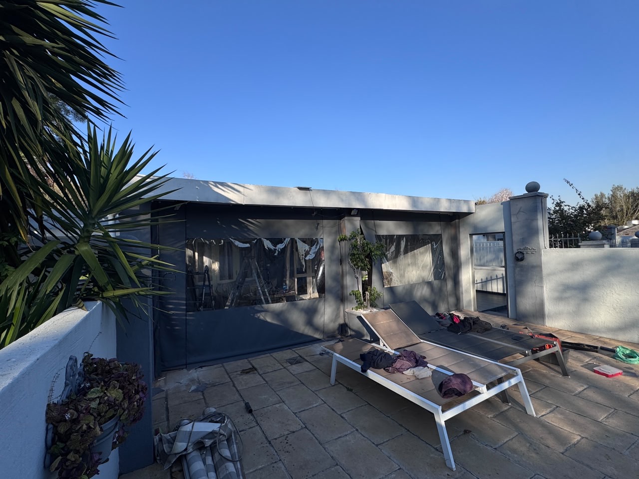 Charcoal canvas blinds on a modern poolside entertainment area